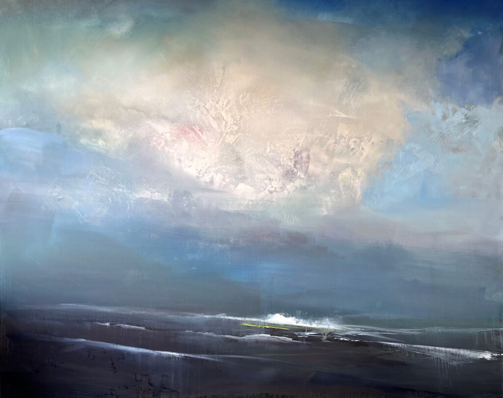 A cloudy sky over a calm seashore with gentle waves.