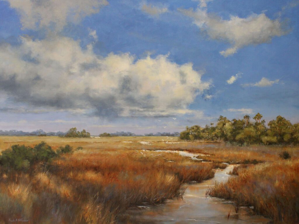 A serene marshland with a winding waterway under a partly cloudy sky.