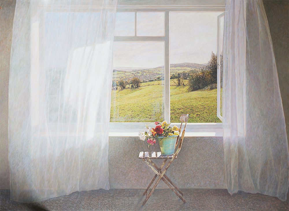A cozy room with sheer curtains and a small table by a window overlooking a green field.