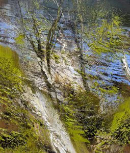Reflection of trees and sky on a rippling water surface.