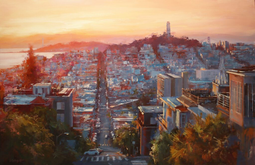 Sunset over a city with a tall tower on a hill.