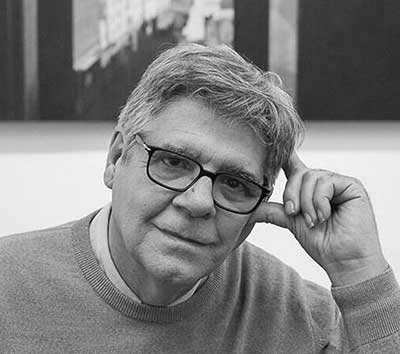 Portrait of a middle-aged man with glasses in grayscale.