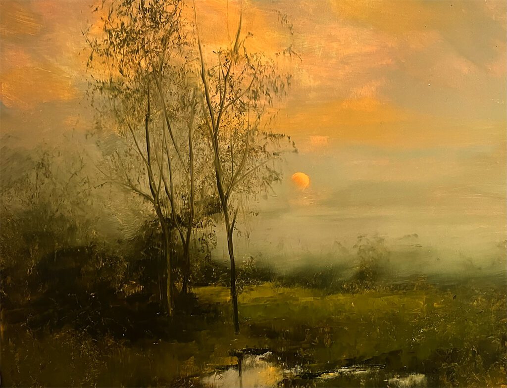 Sunset over serene landscape with trees