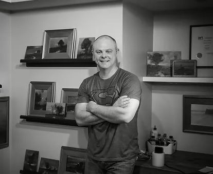 Man standing in art-filled room