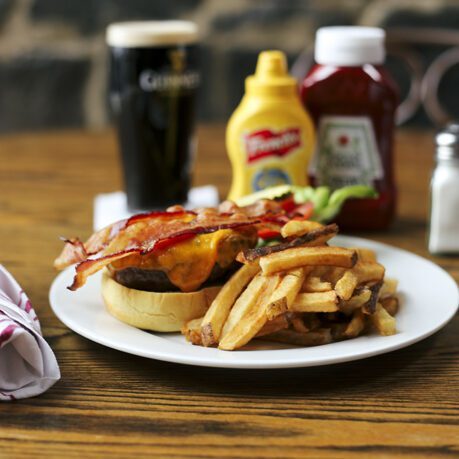Bacon cheeseburger served with fries