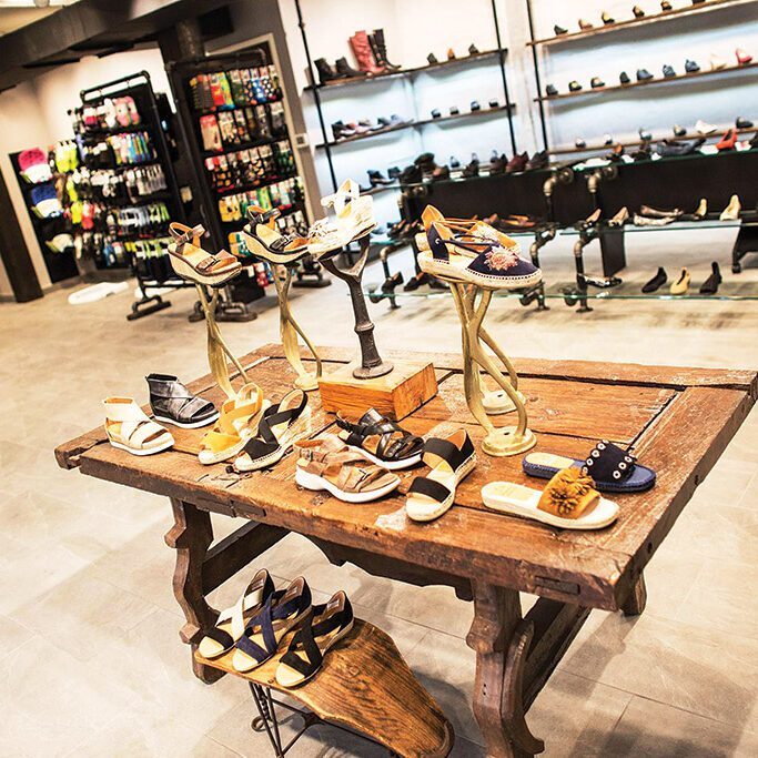 Assorted sandals on wooden display table